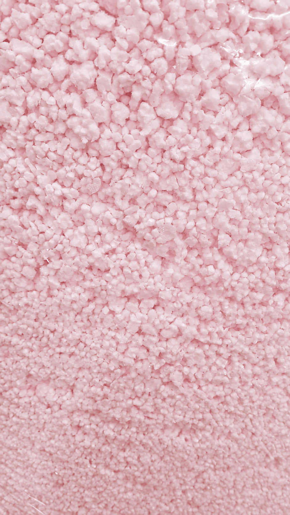 Close-up of EPP regrind filling with irregular particles and a pale pink tint
