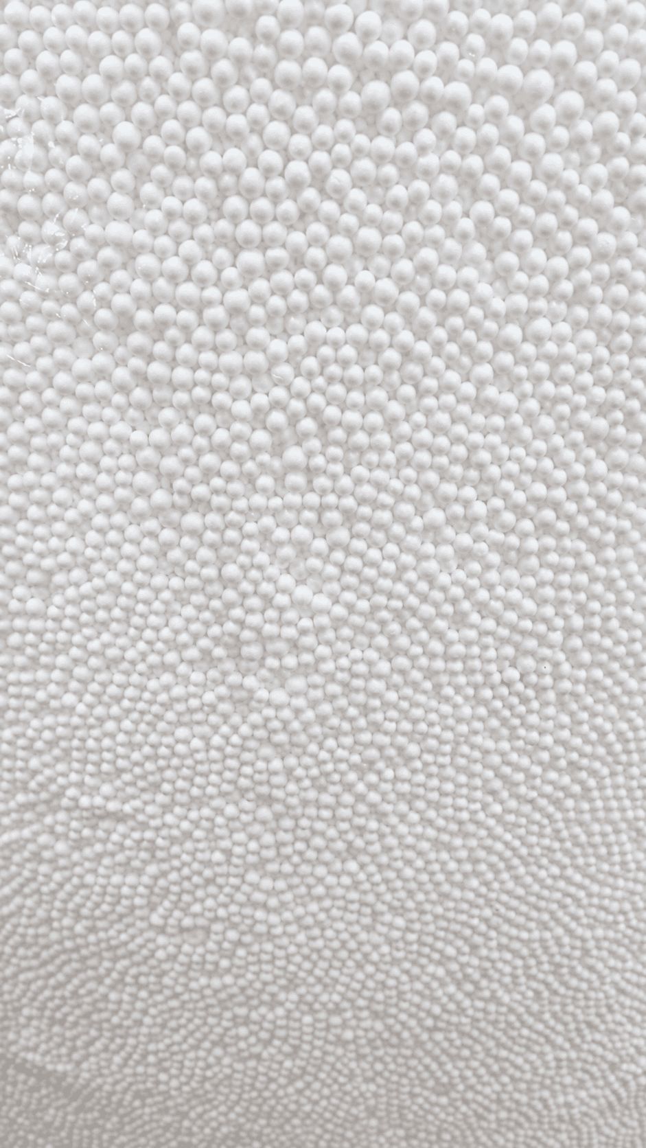 Close-up of round white virgin polystyrene filling beads